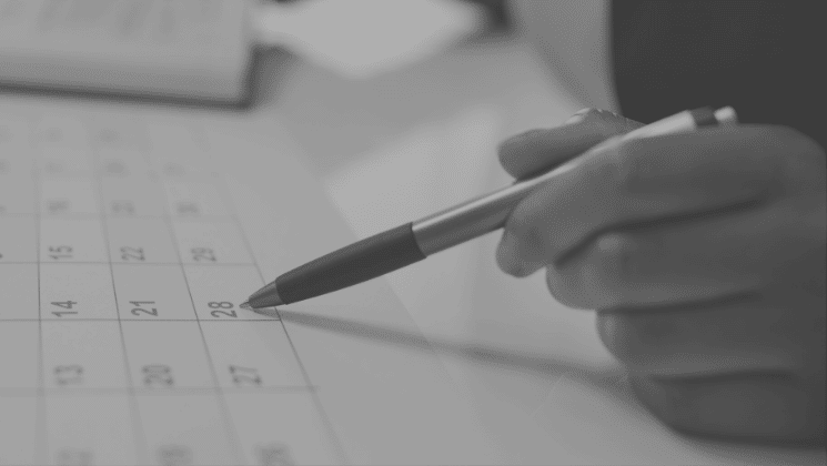 Hand pointing in a calendar, planning and scheduling